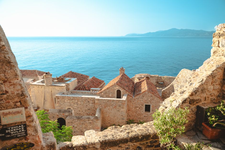 Monemvasia fortress Greece medieval stone walls fishing boats harbor