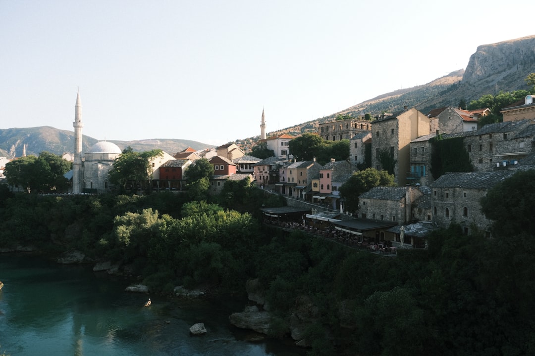 Mostar riverfront bars night lights Stari Most reflection