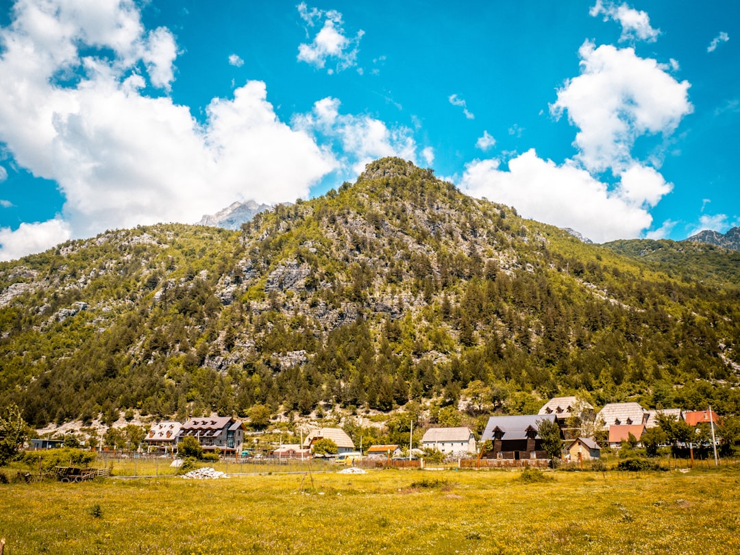 Theth village Albania stone houses mountain backdrop