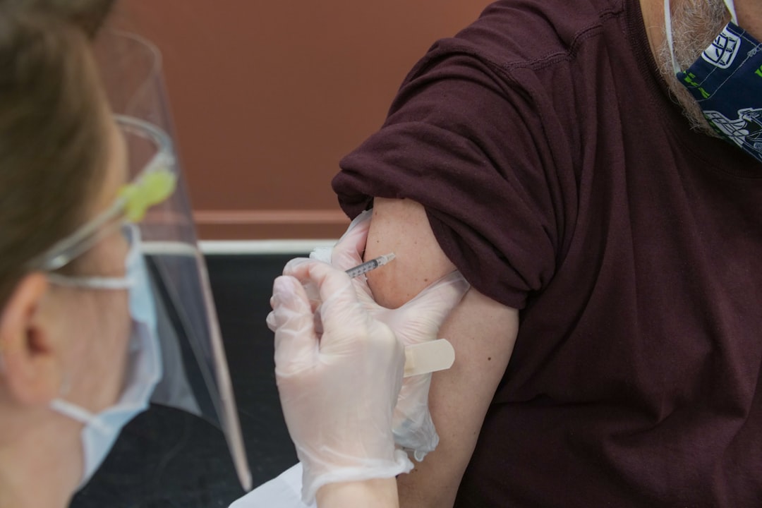 doctor administering flu vaccine syringe