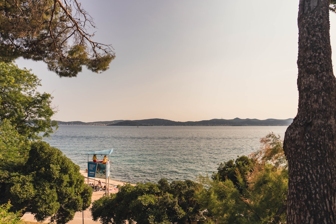 Zadar sunset pebble beach calm sea warm light evening atmosphere