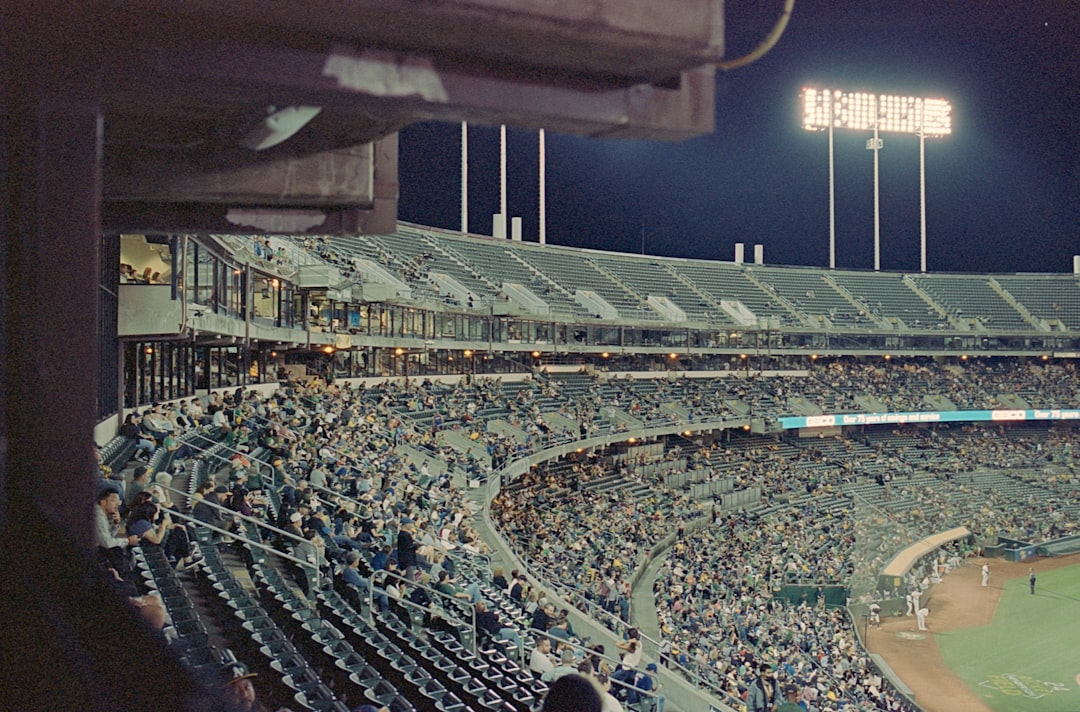 Oakland Coliseum exterior night lights baseball stadium
