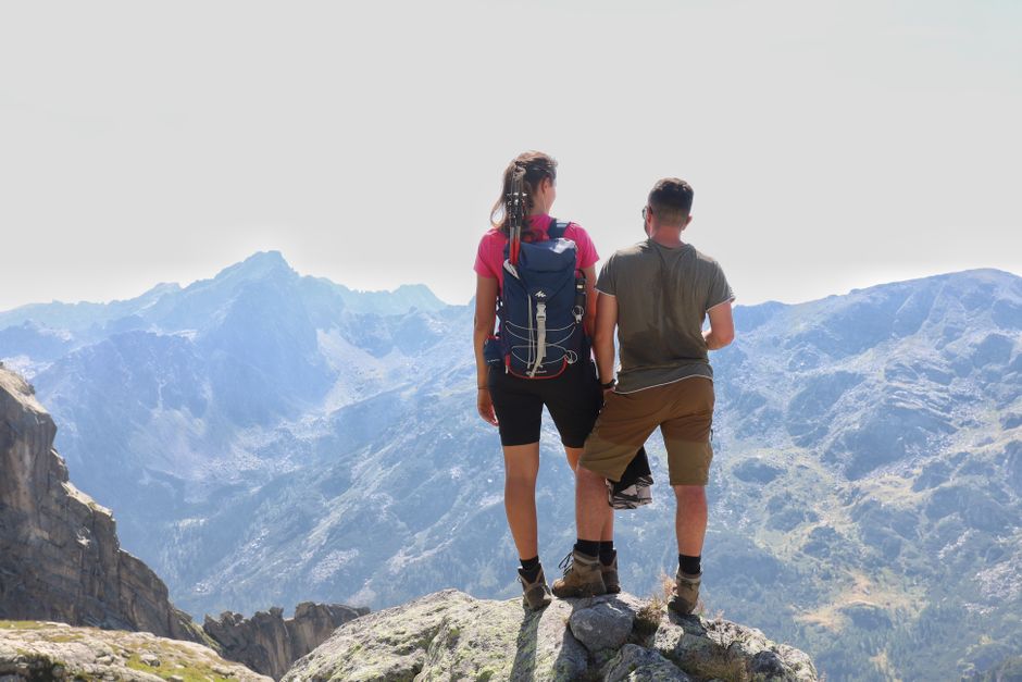 Hikers scrambling rocky ridge Maglic peak Bosnia high altitude exposure