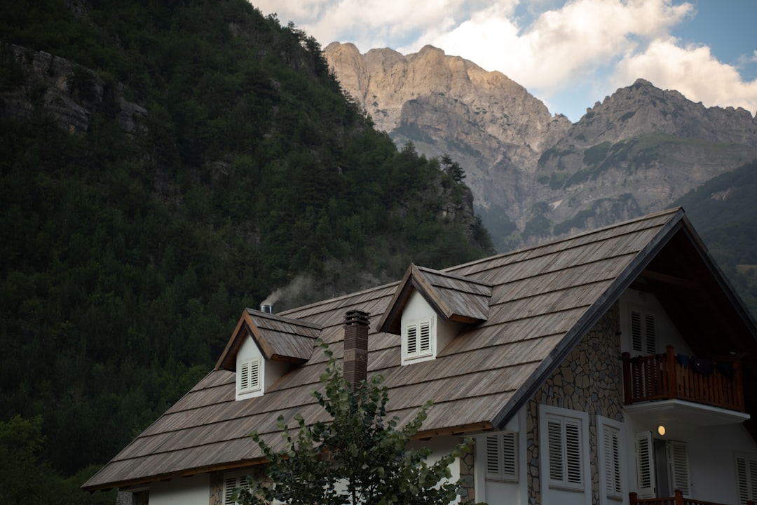 Traditional stone guesthouse exterior in Theth village Albania evening light