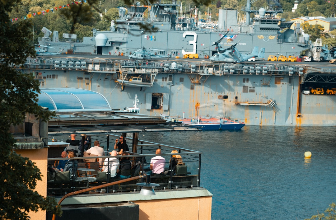 Swedish flag flying alongside NATO emblem Stockholm