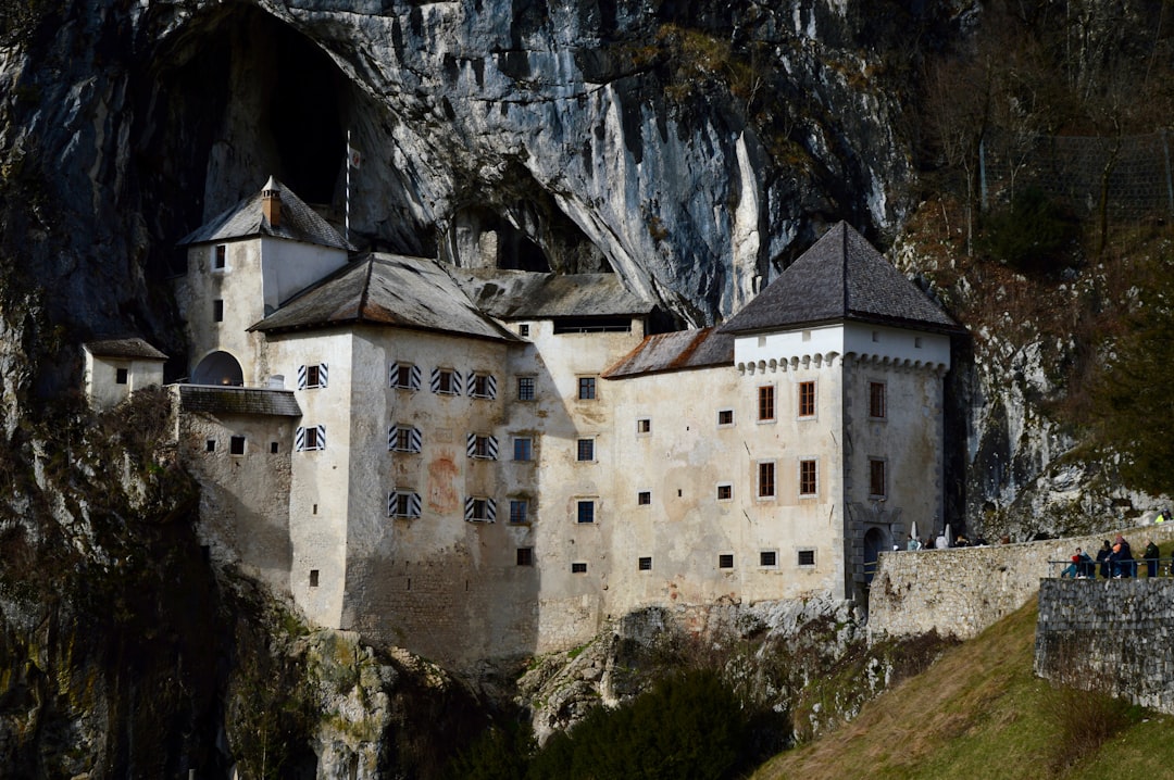 Postojna Cave entrance exterior steam train tourists Slovenia