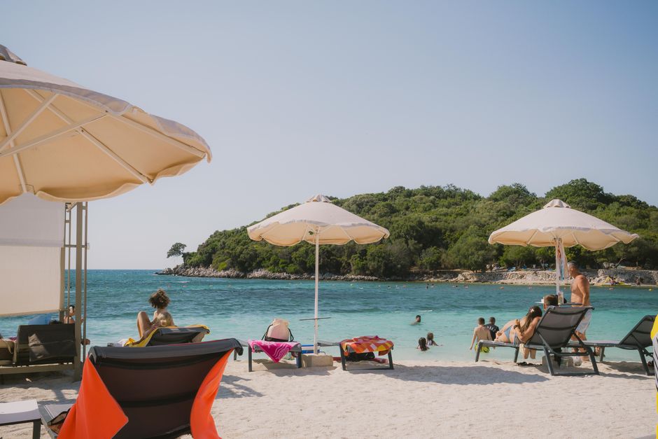 Ksamil Albania beach turquoise water white pebbles small islands