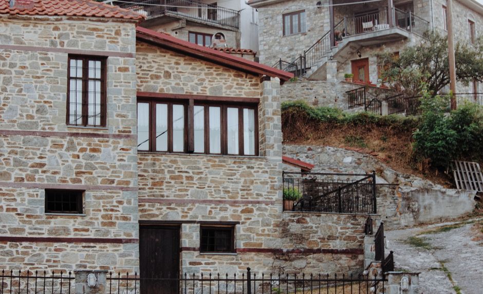 Stagira Village Greece traditional stone houses Mount Olympus background