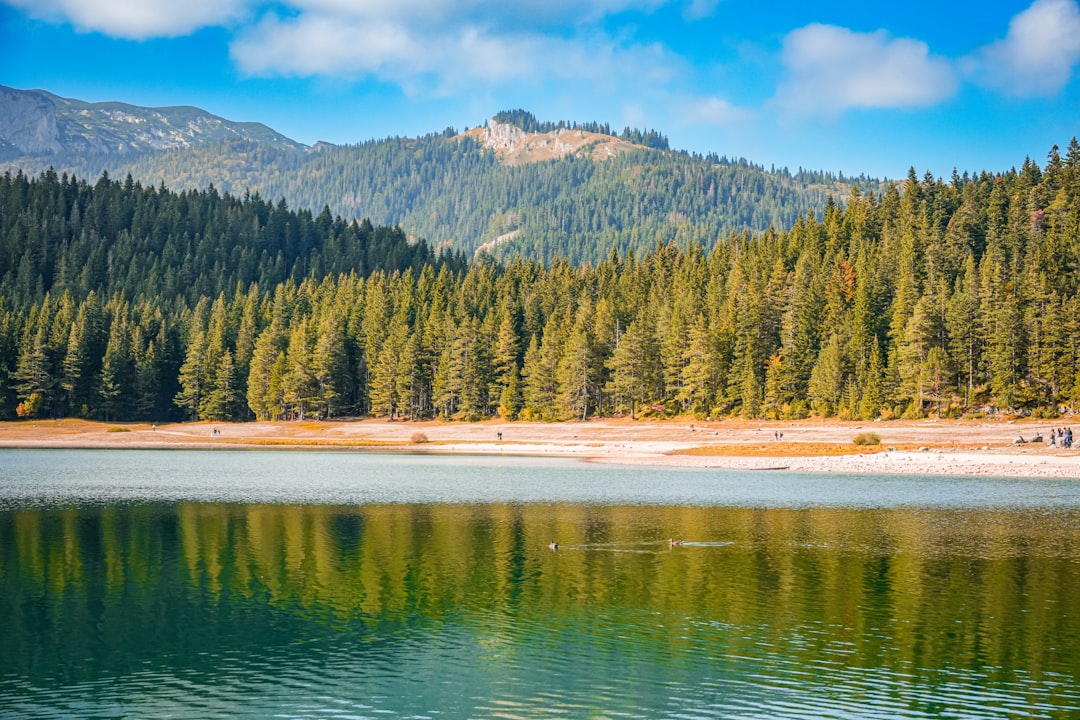 Black Lake Durmitor Montenegro blue water rowboats mountain reflection