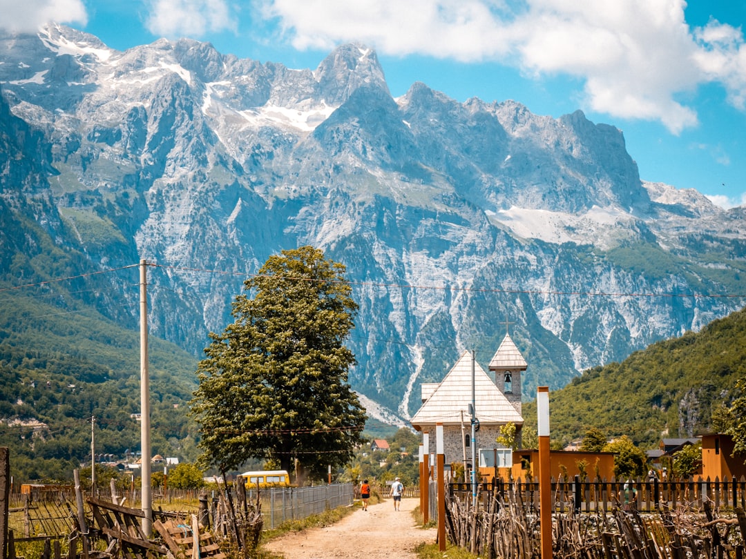 Theth Village Albania traditional stone houses wooden balconies mountain backdrop
