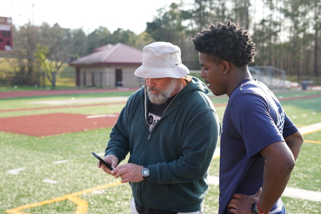 Football scout analyzing player data tablet screen