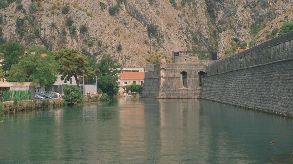 Kotor Fortress Walls Montenegro steep limestone staircase tourist climbing summer sun