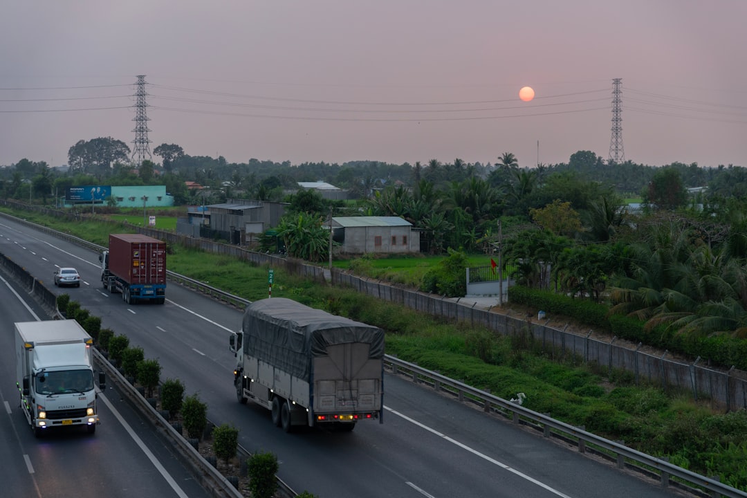 Balkan highway truck convoy sunset