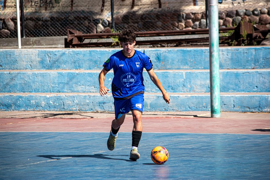 Young footballer dribbling with Nike T90 boots on urban court