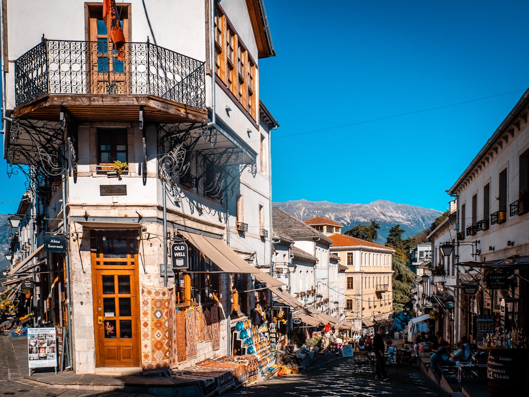 Bazaar Street Gjirokastër stone buildings shops tourists morning light
