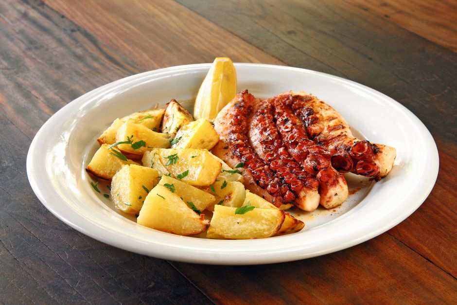 Viganj local restaurant grilled octopus plate table