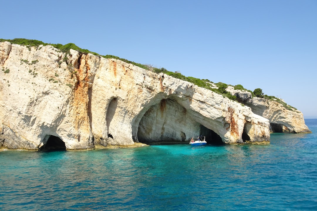 Biševo Blue Cave Croatia sunlight reflection turquoise water small boat