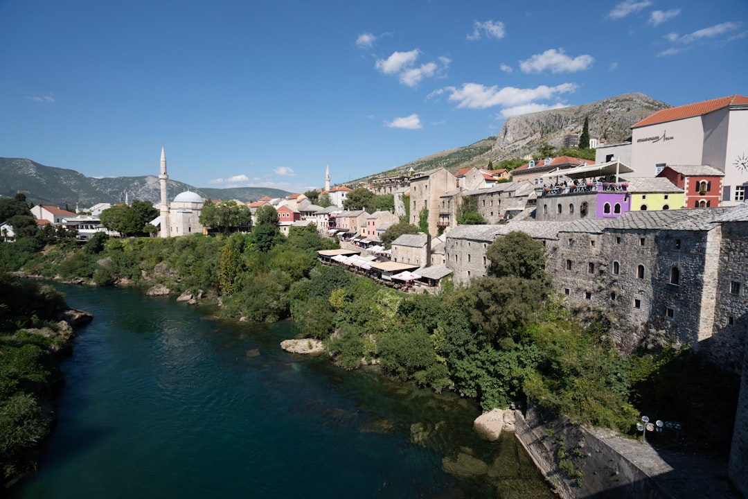 Mostar nightlife bar terrace overlooking Neretva River night lights