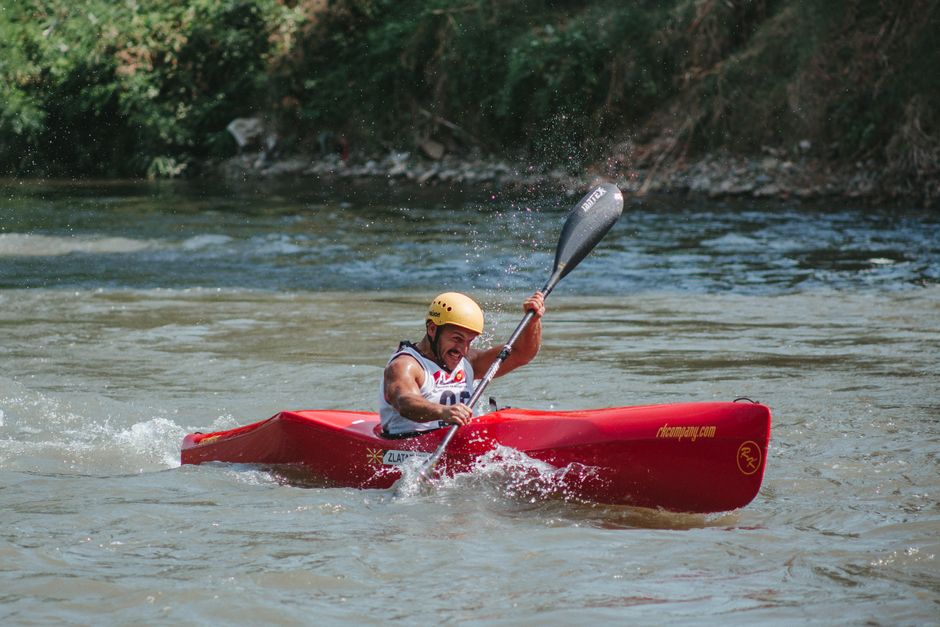 Kayaker in green boat navigating whitewater rapids Tara River Serbia