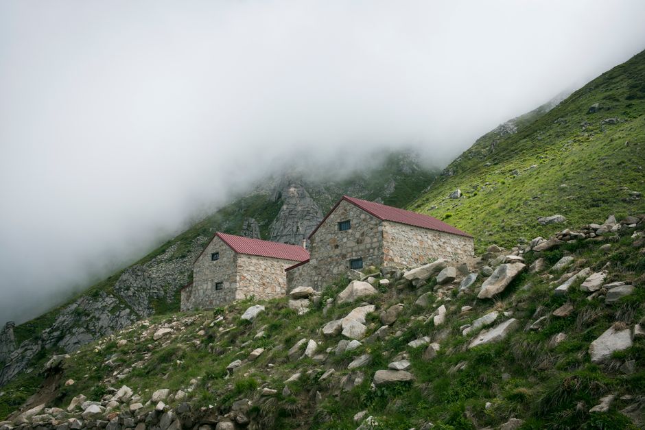 Bislat village Kosovo stone houses morning mist mountains background
