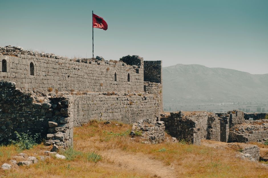 Serbian and Albanian flags waving together outdoors